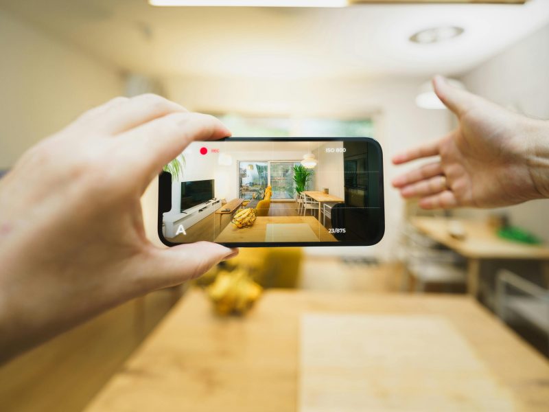 Interactive virtual tour of a contemporary living room using a smartphone.