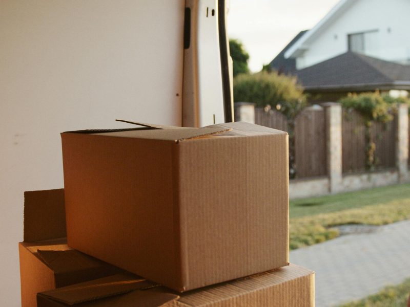 View inside a delivery van with stacked cardboard boxes ready for moving.